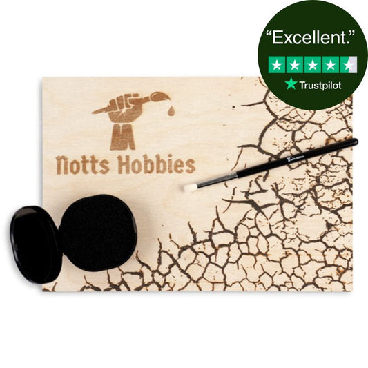 Drybrushing kit with a wooden palette, drybrush, and dampening sponge on a white background.
