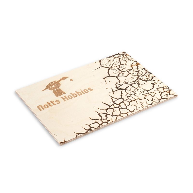 Wooden drybrush palette with laser-cut design on a white background